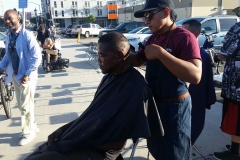 A homeless black man gets his hair trimmed.
