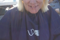 AFTER: A homeless woman in a wheelchair after her hair cut.