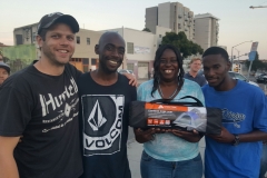 Ryan hugs homeless Willam, Tonya, and Dominic after presenting them with a tent.