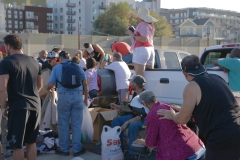 Yvette stands on a truck bed with her camera taking amazing photos of the homeless.