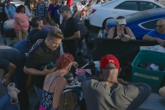Streets of Hope volunteers help the homeless find clothing.