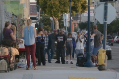 Talking to the homeless while the food is being prepared to serve.