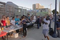 The feeding line for the homeless starts to pass out food.