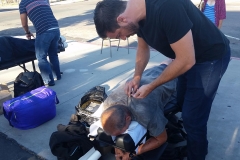 Eric helps a homeless man with his chiropractic services.