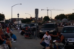 Panoramic view of the hair cutting, massages, and chiropractors and food line on both sides of the street.