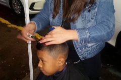 Cutting a little boy's hair at our downtown San Diego homeless Thanksgiving event.
