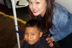 Tammy cuts Santos' hair at our San Diego downtown homeless event.