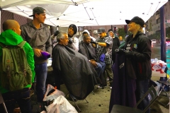 Cutting the homeless hair in the rain in downtown San Diego during Thanksgiving.