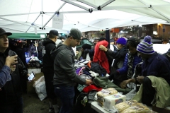 Volunteers help the homeless with the clothing donations.