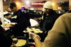 Handing out desserts to compliment the homeless Thanksgiving dinner.