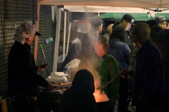 Flipping burgers and hot dogs in addition to serving Turkey on Thanksgiving for the homeless.