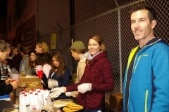 Sunshine and Alex smile as the food line volunteers for the homeless prepare to serve a Christmas meal.