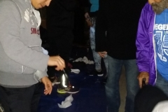 Helping the homeless with new running shoes in downtown San Diego.