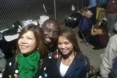 Smiles while serving the homeless. Notice Tammy praying for Shelia in the background.
