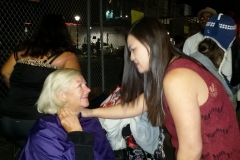 Tammy talks to Shelia, a homeless woman, about her hair style