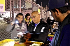 Paul helps a homeless size up his feet for a new pair of running shoes.