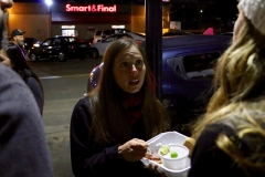 Jenn helps a homeless woman with her Christmas meal.
