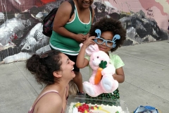 Victoria laughs as little homeless girl Lauren accepts her birthday gifts.