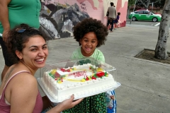 Victoria presents little homeless Lauren with a birthday cake. Look at that smile!
