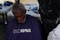 Faith cuts a homeless man's hair in downtown San Diego.