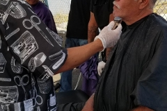 Mario cuts a homeless man's hair in downtown San Diego.