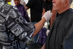 Mario cuts a homeless man's hair in downtown San Diego.