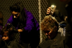 Cutting the homeless hair in the dark to cell phone flashlights on Thankgiving