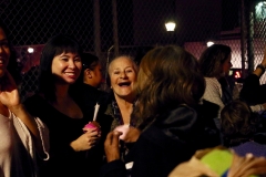 Homeless volunteers smile and laugh while helping the homeless on Thanksgiving