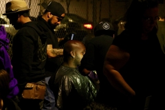 A homeless man gets his beard trimmed in downtown San Diego