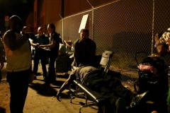 Alex, Street of Hope San Diego chiropractor volunteer, adjusts a homeless man's neck right on the streets at our Thanksgiving homeless event.