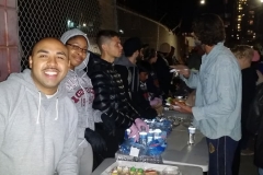 Homeless volunteers feed the homeless on Christmas as the line up in the food line.