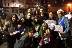 Some of the homeless volunteer pose for a photo of some of the Christmas gifts we handed out to the homeless children.