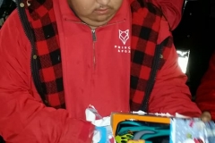 A homeless boy opens his Christmas gift at our special Christmas homeless event.