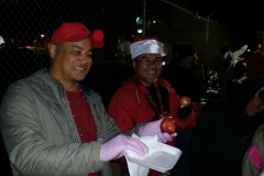 Our volunteers always wear gloves and smiles when feeding the homeless downtown.