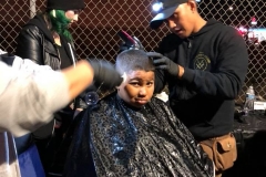 Wylie from Country Club Barber Shop cuts a homeless child's hair on Christmas