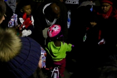 Little homeless girl, Christiana, tries out her bike the volunteers gifted her.