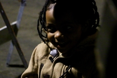 Christiana, a little homeless girl, on Christmas in downtown San Diego smiles after getting a gift.