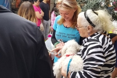 St. Paco's Second Chance Dog Rescue worker, Sandra, helps Diane fill out ownship paperwork for Goya.
