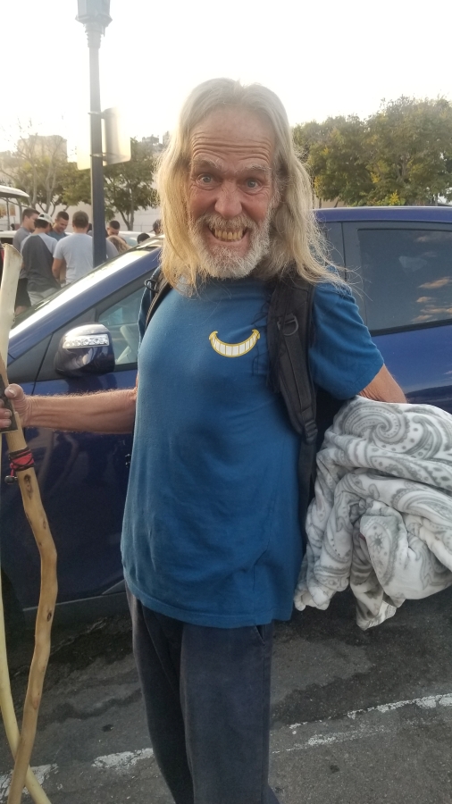 A homeless man appreciates his blanket donated by Newport Pacific.