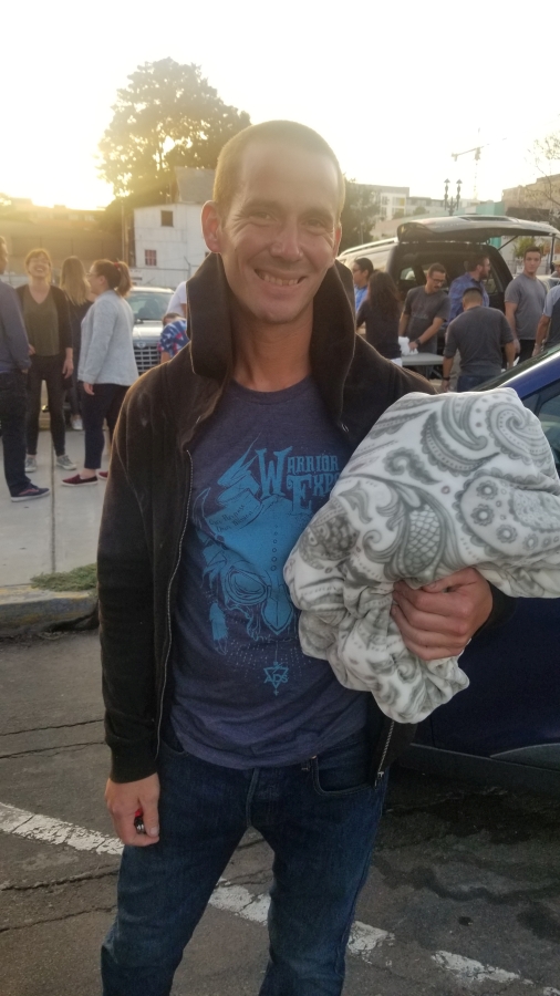 A San Diego homeless man receives a blanket.