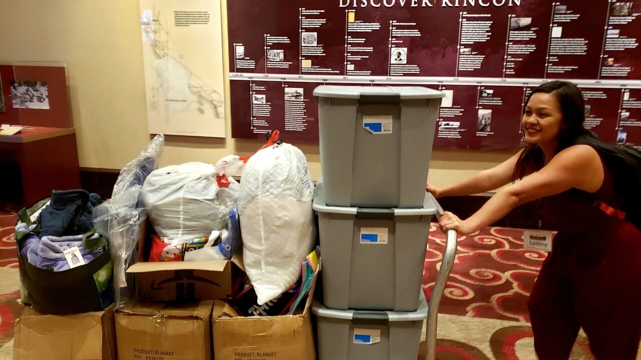 Tammy pushes one of the cards full of donations made by Newport Pacific for San Diego's homeless