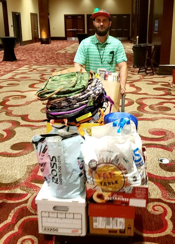 Nate wheels out a palette full of donations for San Diego's homeless from Newport Pacific