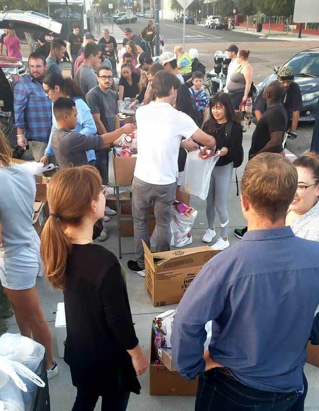 Streets of Hope volunteers filling up donation bags for the homeless.
