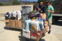 Zo and Nate begin to fill up the truck with some of the donations from Newport Pacific