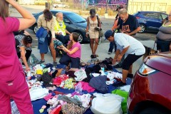 Some downtown San Diego's homeless receiving clothing, blanks and toiletries donated by Newport Pacific