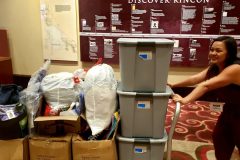 Tammy pushes one of the cards full of donations made by Newport Pacific for San Diego's homeless
