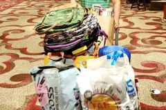 Nate wheels out a palette full of donations for San Diego's homeless from Newport Pacific