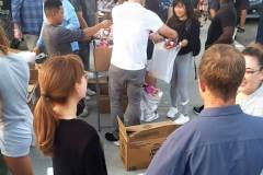 Streets of Hope volunteers filling up donation bags for the homeless.