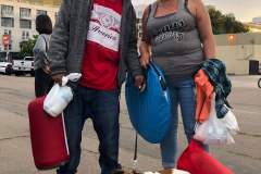 A homeless couple with a tent and sleeping bags in downtown San Diego