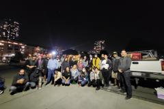 Jeramiah,  downtown San Diego homeless man (far left 1st row) receives a sleeping bag, and another, Eitian, received a tent.